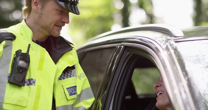 4K Driver in her car flirting with traffic policeman. Slow motion.