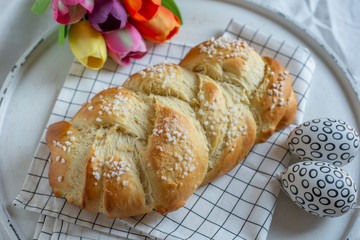 Home made sweet braided bread on a wooden board
