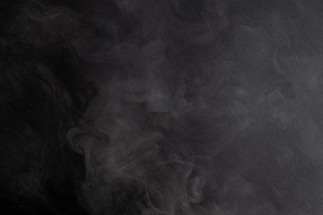the abstract flow of smoke from a black background.