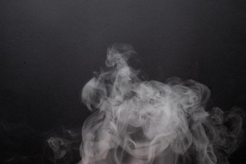 the abstract flow of smoke from a black background.