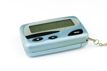 Fototapeta premium Close-up old a cyan metallic pager or beeper is put lying on white floor, isolated with clipping path on white background.