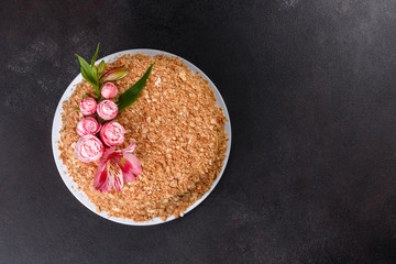 Fresh delicious cake napoleon with cream on a dark background