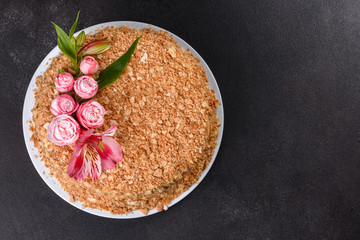 Fresh delicious cake napoleon with cream on a dark background