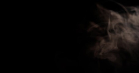 Close up of male hand throwing two poker cards away with smoke in the black background shot in 4k super slow motion