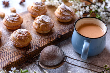 Fresh baked cupcakes of rice flour with banana and vanilla with a mug of hot chocolate