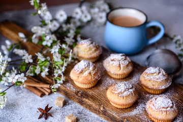 Fresh baked cupcakes of rice flour with banana and vanilla with a mug of hot chocolate