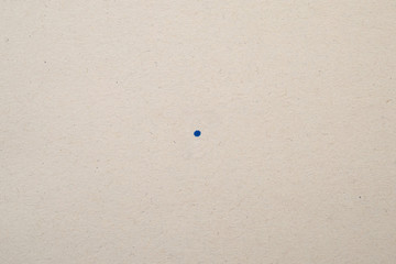 a dot symbol stamped on a piece of paper.