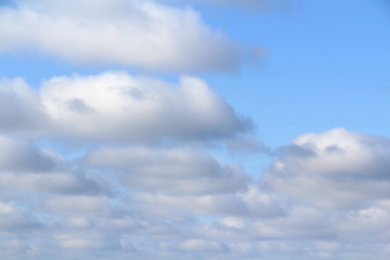 Lovely white fluffy clouds on a background of blue sky.