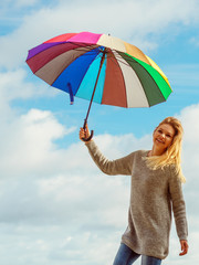 Happy woman holding umbrella