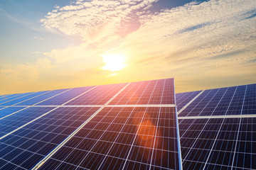 Photovoltaic solar panels on sunset sky background,green clean energy concept.