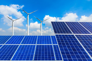 Solar panels with wind turbines on a sunny day,green clean energy concept.