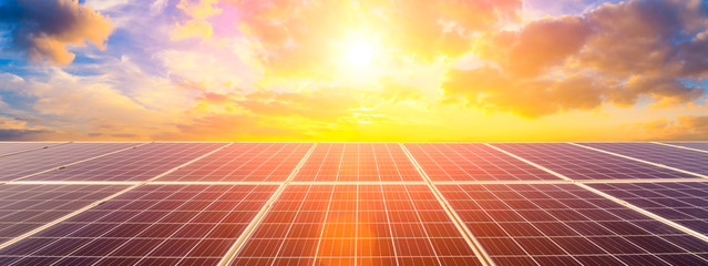 Photovoltaic solar panels on sunset sky background,green clean energy concept. - obrazy, fototapety, plakaty