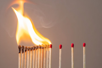 matchsticks burning and gap distance showing preventative containing coronavirus pandemic with copy...