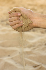 Woman hands letting sand run out