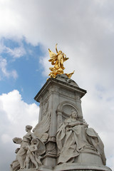 Fototapeta na wymiar Gilded Winged Victory at the top of the Victoria Memorial in front of Buckingham Palace in a sunny day, London, UK