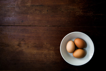 eggs in a tiled bowl with a wooden background