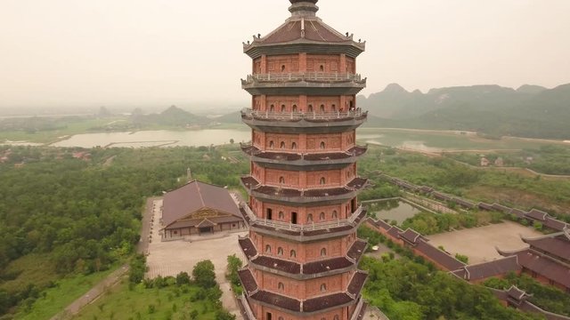 Aerial Circle Descending Shot of Xa Loi stupa at Bai Dinh Temple Spiritual and Culture Complex in Ninh Binh Vietnam, the largest spiritual tourist place in Vietnam