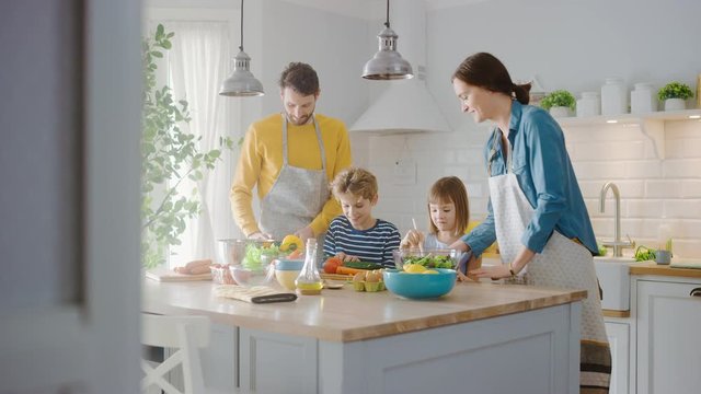 In Kitchen: Family of Four Cooking Together Healthy Dinner