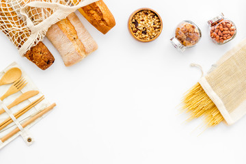 Glass jars, cotton bags on white background, top view. Eco friendly concept for kitchen - food storage copy space