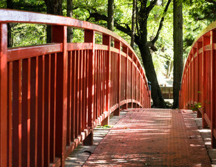 Red bridge across the Togawa river leading to Manji Stone Buddha in Shimosuwa - Nagano prefecture, Japan