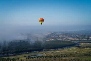 Hot air balloon flying in the mist above Canberra, Australia