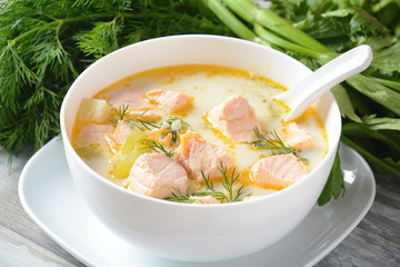 Creamy fish soup with salmon, potatoes, onions , carrots, dill and celery . Kalakeitto-traditional dish of the Finnish cuisine or Russian Ukha Fish Head Soup. Healthy Food Concept. Omega-3