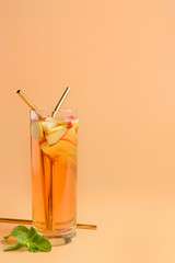 Glass of tasty cold ice tea on color background