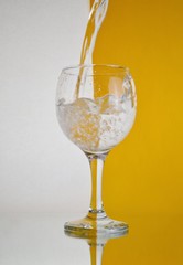 glass of water on the white and yellow background 