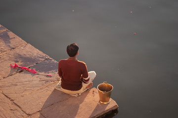 man meditating at Pushkar lake