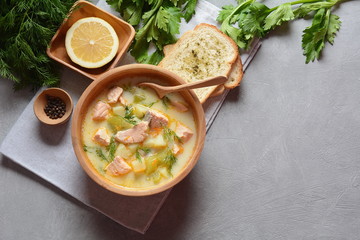 Creamy fish soup with salmon, potatoes, onions , carrots, dill and celery . Kalakeitto-traditional dish of the Finnish cuisine or Russian Ukha Fish Head Soup. Healthy Food Concept. Omega-3