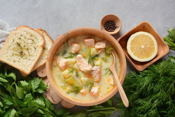 Creamy fish soup with salmon, potatoes, onions , carrots, dill and celery . Kalakeitto-traditional dish of the Finnish cuisine or Russian Ukha Fish Head Soup. Healthy Food Concept. Omega-3