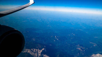View from plane window on Planet Earth, Alps Mountains.