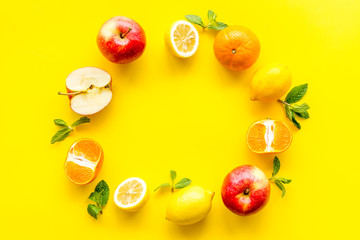Colorful fruit mockup. Cut apple, kiwi, citrus on yellow background top-down copy space