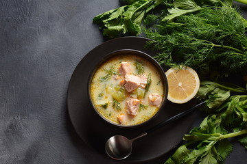 Creamy fish soup with salmon, potatoes, onions , carrots, dill and celery . Kalakeitto-traditional dish of the Finnish cuisine or Russian Ukha Fish Head Soup. Healthy Food Concept. Omega-3