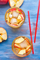 Glasses of tasty cold ice tea on color wooden background