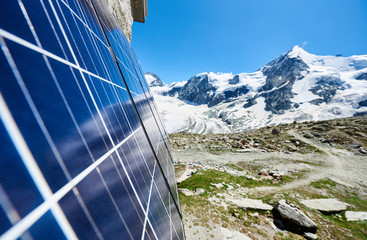 Close-up perspective snapshot of solar modules installed on the walls of alpine tourist hut in...