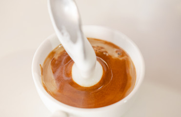 Barista making a cup of coffee soft focus image 