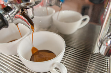 Barista making a cup of coffee soft focus image 