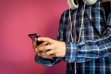 Teen boy with headphones and smart phone