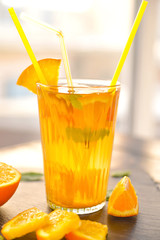 Glass of tasty cold ice tea on table