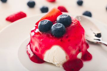 Tasty panna cotta on plate, closeup