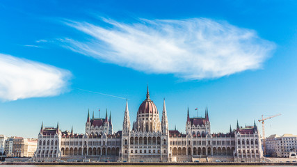 Fototapeta na wymiar Hungarian parliament building with beautiful clouds in sunny day in Budapest