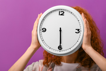 Woman with clock on color background. Time management concept