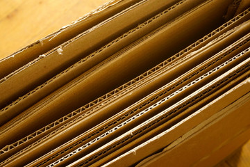 Close-up of stacked corrugated cardboard. Sheets of brown corrugated cardboard.