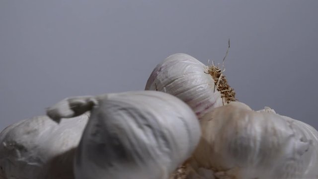 Close up of garlic bulbs with skins on 4K