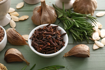 Different spices on color wooden background