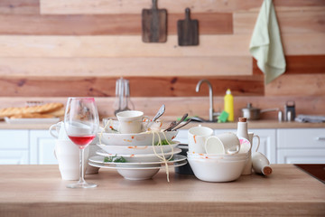 Many dirty dishes on kitchen table
