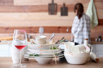Many dirty dishes on kitchen table