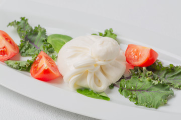 Fresh Italian buratta cheese with tomatoes.
