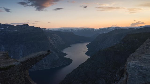 Time lapse of Trolltunga mountain cliff, most famous mountain hiking route in Norway in summer season at sunset